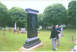 Carmon Hicks and Floyd Thomas at Delany's granite headstone